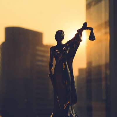 small statue of lady justice in window